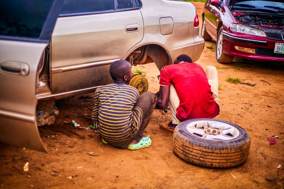 Mechanic performing car tire replacement in a professional garage